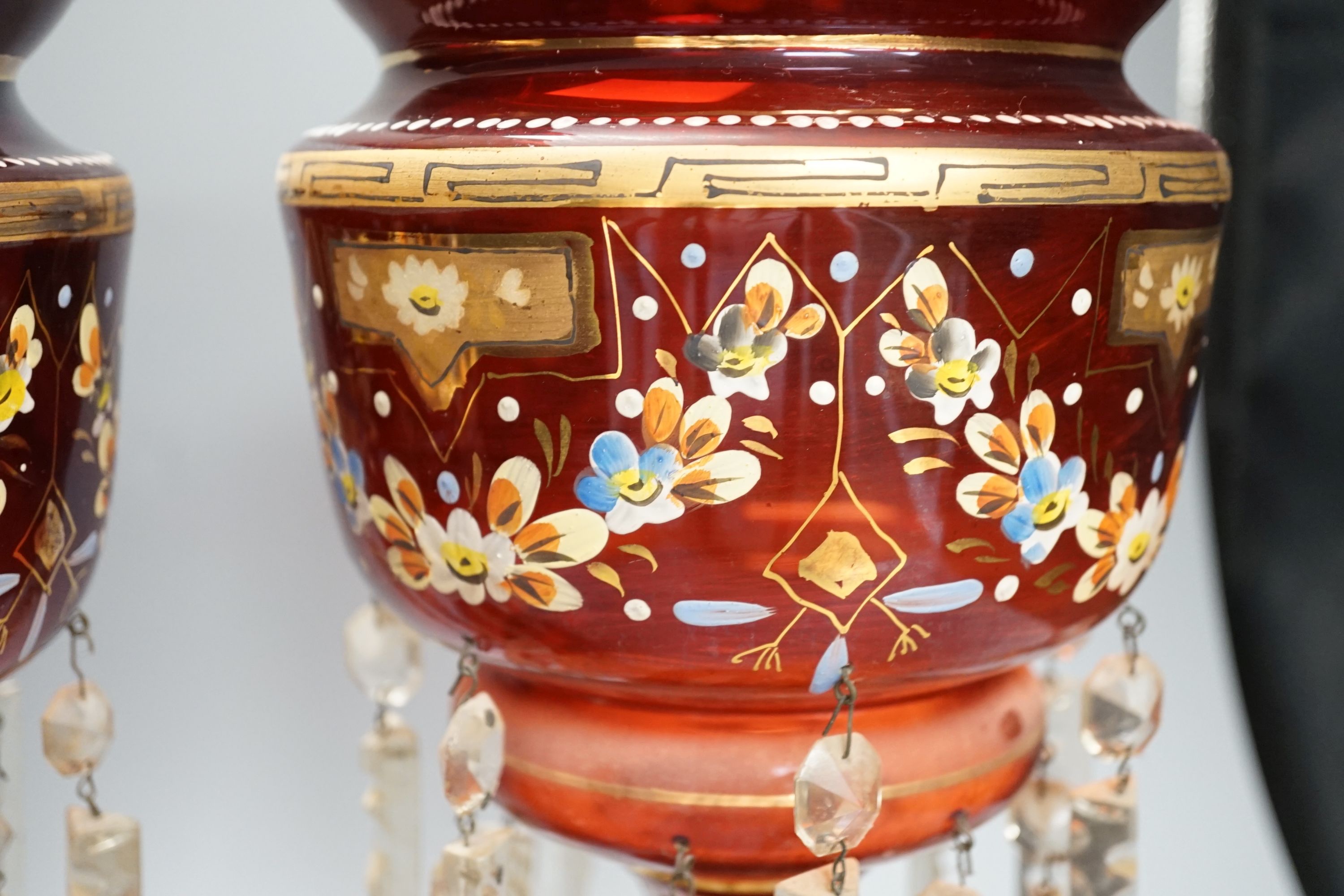 A pair of late 19th century ruby glass and enamel lustres - 36cm high